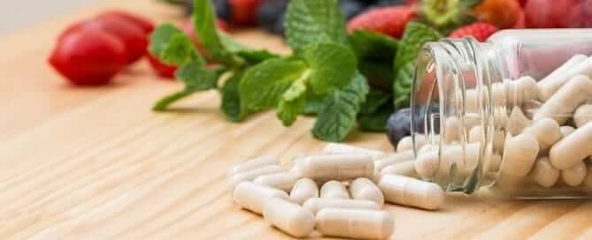 Supplements with fruit in background