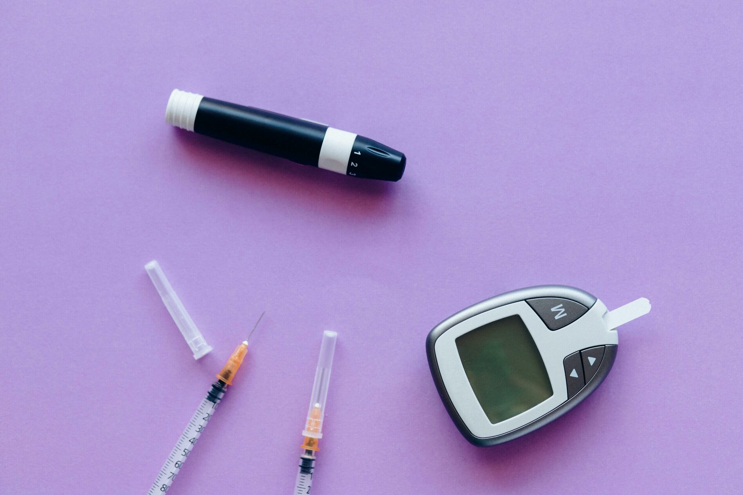 Insulin supplies on a purple surface