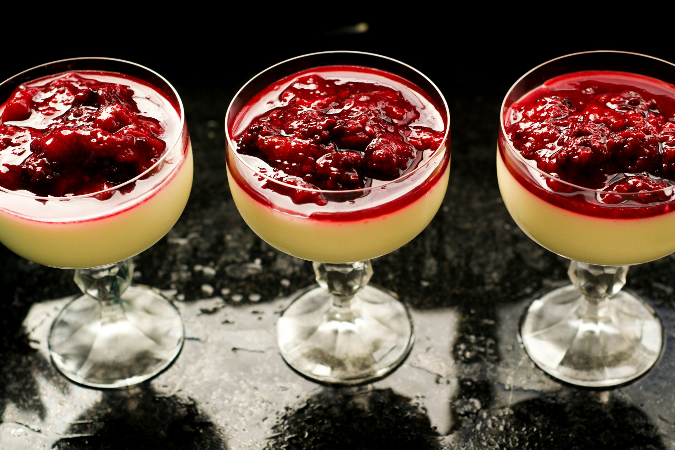 Three pudding cups with cranberry topping