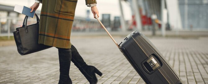 A woman with luggage at an airport