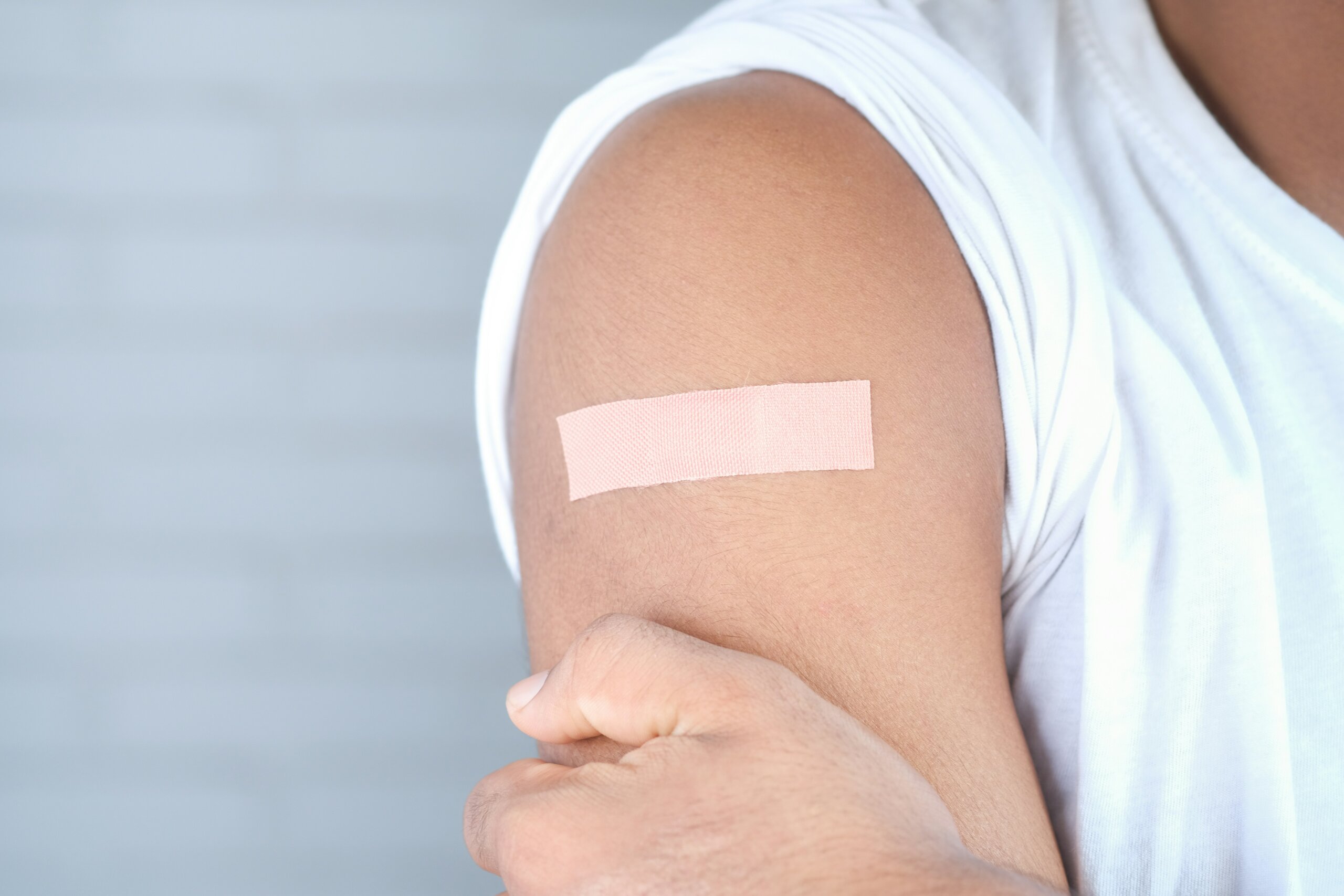 A person’s arm dressed with medical tape