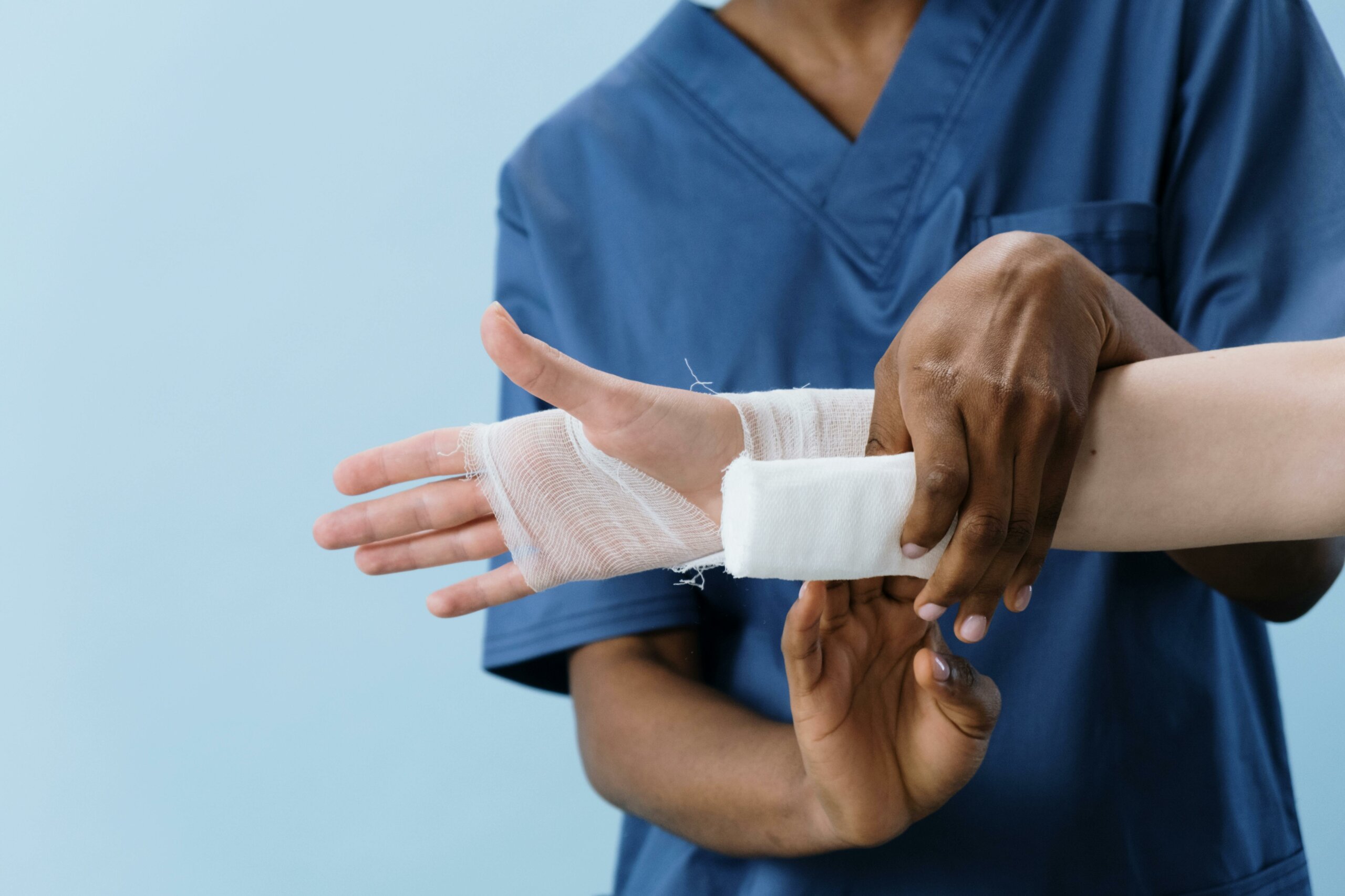 A nurse bandaging a patient's wrist